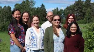 Group photo of Haapaniemi Lab members attending the retreat, facing the camera and smiling.